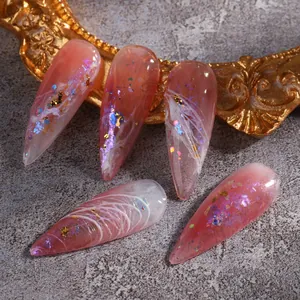 Macro shot of pink aurora opal nail sequins and gold foil details on jelly stiletto nails
