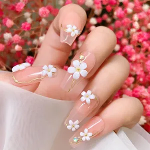 Close-up of 3D white flower resin charms and pink gradient on long coffin press-on nails