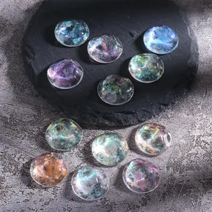 Close-up of iridescent aurora opal nail flakes with laser glass effect on dark stone