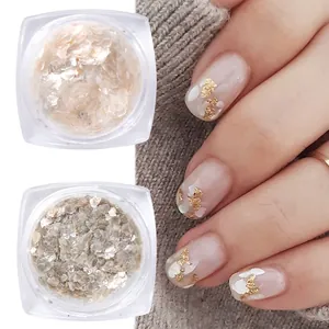 Detail of champagne gold and silver nail mica flakes in jars with manicure effect display