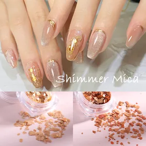 Macro detail of shimmer mica nail art flakes in champagne gold and copper tones