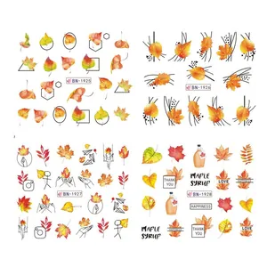 Detail of four water transfer nail stickers with autumn maple leaf and squirrel designs