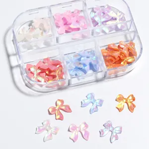 Macro shot of colorful iridescent resin bow charms stored in a six-grid plastic box