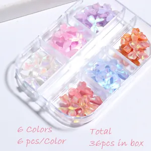 Detail of 36pcs aurora resin bow nail charms in a 6-grid clear storage box