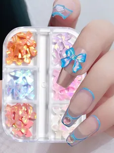 Detail of aurora resin bow nail charms in a 6-grid box with iridescent finish