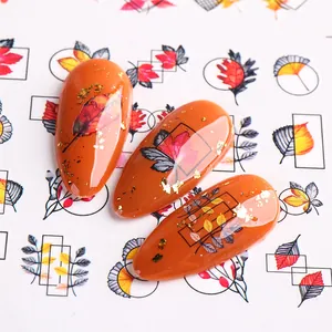 Autumn maple leaf nail stickers with caramel orange finish and gold foil accents