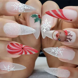 Close-up of Christmas press-on nails with snowflakes, reindeer and glittery festive patterns