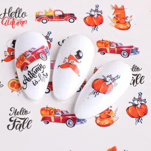 Autumn nail stickers featuring red pumpkin trucks and astronauts on white tips