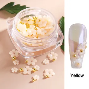 Resin sun flower nail charms in yellow color change effect with metal micro-beads