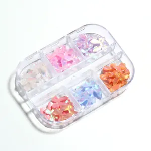 Aurora resin bow nail charms set in six-compartment storage box with pearlescent finish