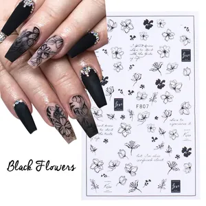 Detail view of F807 black floral nail stickers with Love and Kiss script on almond nails
