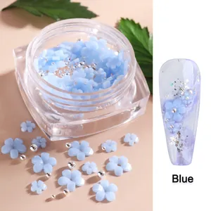 Blue resin flower nail art charms with silver beads in a jar for 3D manicure designs