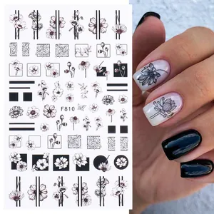 Detail of F810 black and white floral nail stickers featuring daisy and leaf patterns