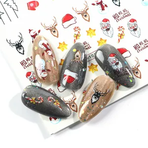 Detailed Christmas nail stickers featuring Santa, reindeer, and snowflakes on glitter nails