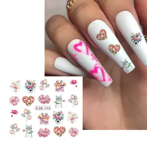 Detailed view of BN-1994 floral and cat water transfer nail art stickers on white base