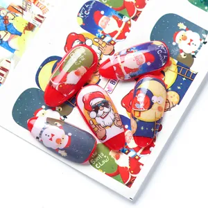 Detail of Christmas nail art stickers featuring Santa Claus and snowman patterns