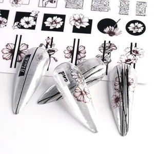 Detailed view of black floral nail stickers with geometric lines on silver glitter nails