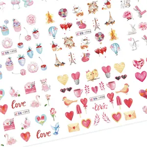 Detail of watercolor nail stickers with Eiffel Tower, donuts, and romantic motifs