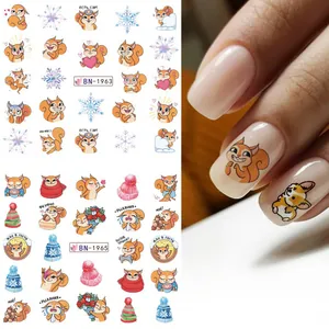 Detail of Christmas nail art stickers featuring squirrels, snowflakes and colorful hats