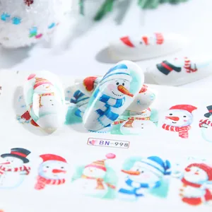 Detail of Christmas nail art stickers featuring snowman designs and snowflake patterns