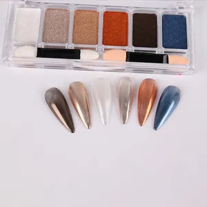 Close-up of 6-color solid mirror nail powder palette with metallic finish and sponge brushes