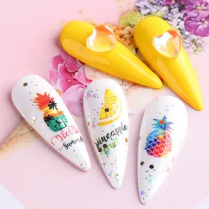 Detail of summer nail art tips with tropical sunset, lemon, and 3D heart decorations