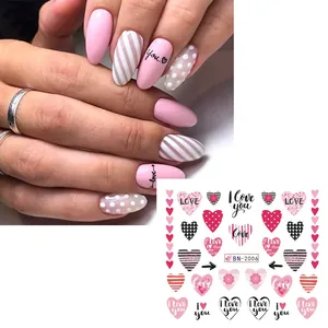 Detailed view of pink heart and love letter water decals for nail art manicure decoration