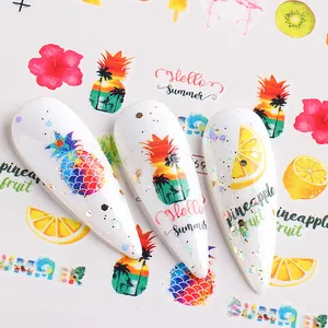 Close-up of tropical summer nail stickers featuring pineapples, lemons and flamingos