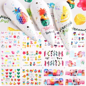 Detail of summer nail art stickers featuring pineapples, lemons, and sunset beach themes