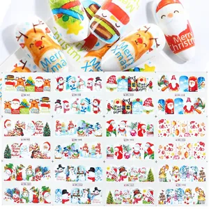 Detail view of 12 Christmas nail stickers featuring Santa, reindeer and snowflakes patterns