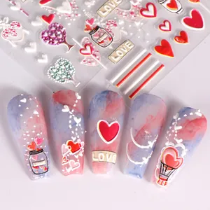 Detail of 5D embossed heart and balloon nail stickers showing 3D texture and romantic patterns