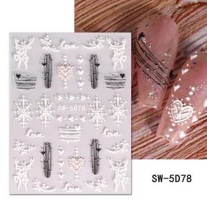 Detailed view of 5D embossed white heart nail stickers and love patterns on pink nails