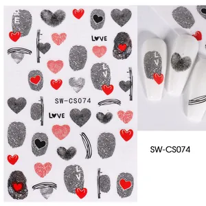 Macro view of 3D nail art stickers with fingerprint heart patterns and LOVE lettering
