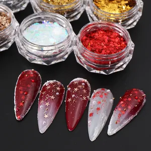 Macro shot of assorted nail sequins in containers with finished red star manicures