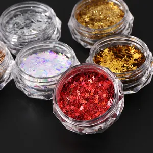 Macro shot of assorted colorful holographic nail art sequins in diamond-shaped containers