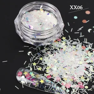 Macro shot of iridescent white star and moon nail sequins in a clear textured jar