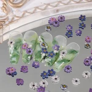 Detail of green marble coffin press-on nails with 3D floral accents and pearls