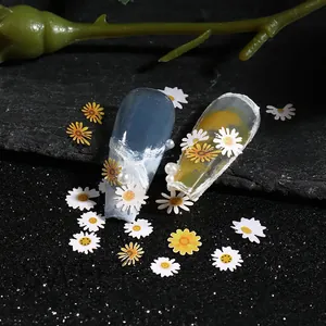 Macro detail of white daisy nail art wood pulp flakes with pearls on floral manicure