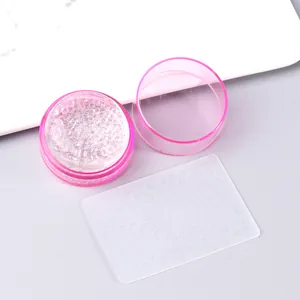 Macro shot of French nail art stamper tool with pink glitter silicone head and XY-205 plate