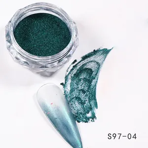 Dark green chrome nail powder in clear jar with gradient effect swatch and manicure tip