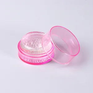 Macro view of a clear pink nail art silicone stamper with glitter and protective lid