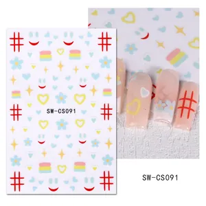 Détail de stickers nail art avec chats, fleurs et carreaux sur des ongles longs roses
