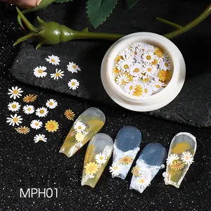 Detail of daisy nail art wood pulp slices on blue nails with white storage container