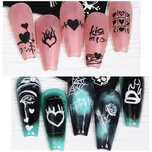Long trapezoidal press-on nails featuring matte pink heart and glossy dark graffiti designs