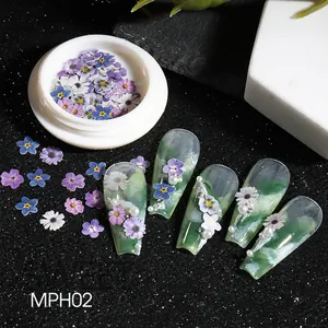 3D flower nail charms with purple and white wood pulp daisies on green manicure nails