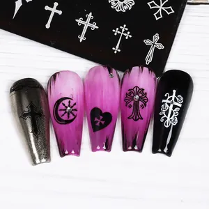 Detailed macro view of Gothic nail art plates featuring cross and heart patterns