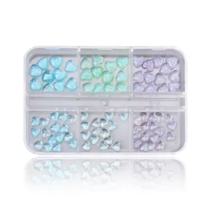 Detail view of 6-grid nail art kit with aurora heart charms and glitter 3D heart shapes
