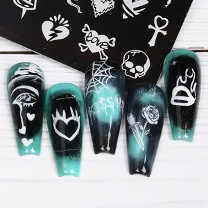 Detailed view of Gothic nail art plates with butterfly and spider web stamp patterns