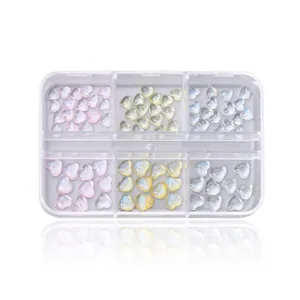 6-grid box of aurora glitter heart nail art charms in pink, yellow and clear tones