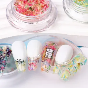 Nail art dried flowers and sequins in transparent jars for floral manicure decoration
